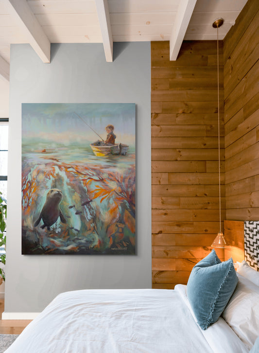 Large painting of a boy fishing above a kelp forest with a seal below, hanging on a bedroom wall beside warm wood paneling and soft lighting.
