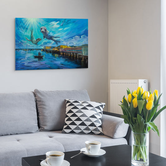 Living room with gray sofa and coffee table, featuring original California fine art of seals near Monterey Pier in soft blue and purple tones