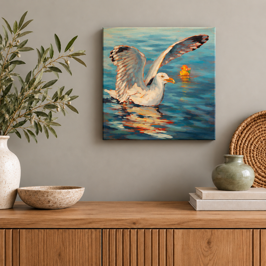 Original 10x10-inch coastal wildlife oil painting by Martina Goulart featuring a seagull spreading its wings beside a yellow rubber duck on blue ocean water, displayed above a wooden cabinet with ceramic decor and greenery in a modern interior.
