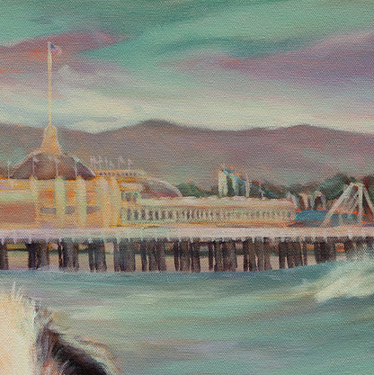 Close-up of the yellow Boardwalk building, ocean, and rollercoasters from the Santa Cruz coastal dog painting.