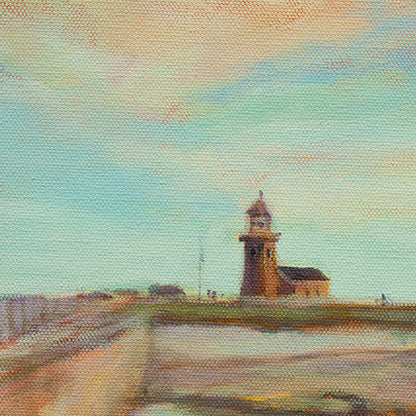 Close-up of the Santa Cruz lighthouse under a clear blue sky with soft yellow and orange clouds from the painting Ocean Scout by Martina Goulart.