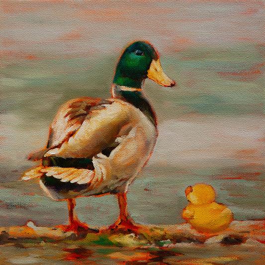 Original painting of a mallard duck with a green head and brown feathers standing beside a yellow rubber duck on wood near calm water, by Martina Goulart.