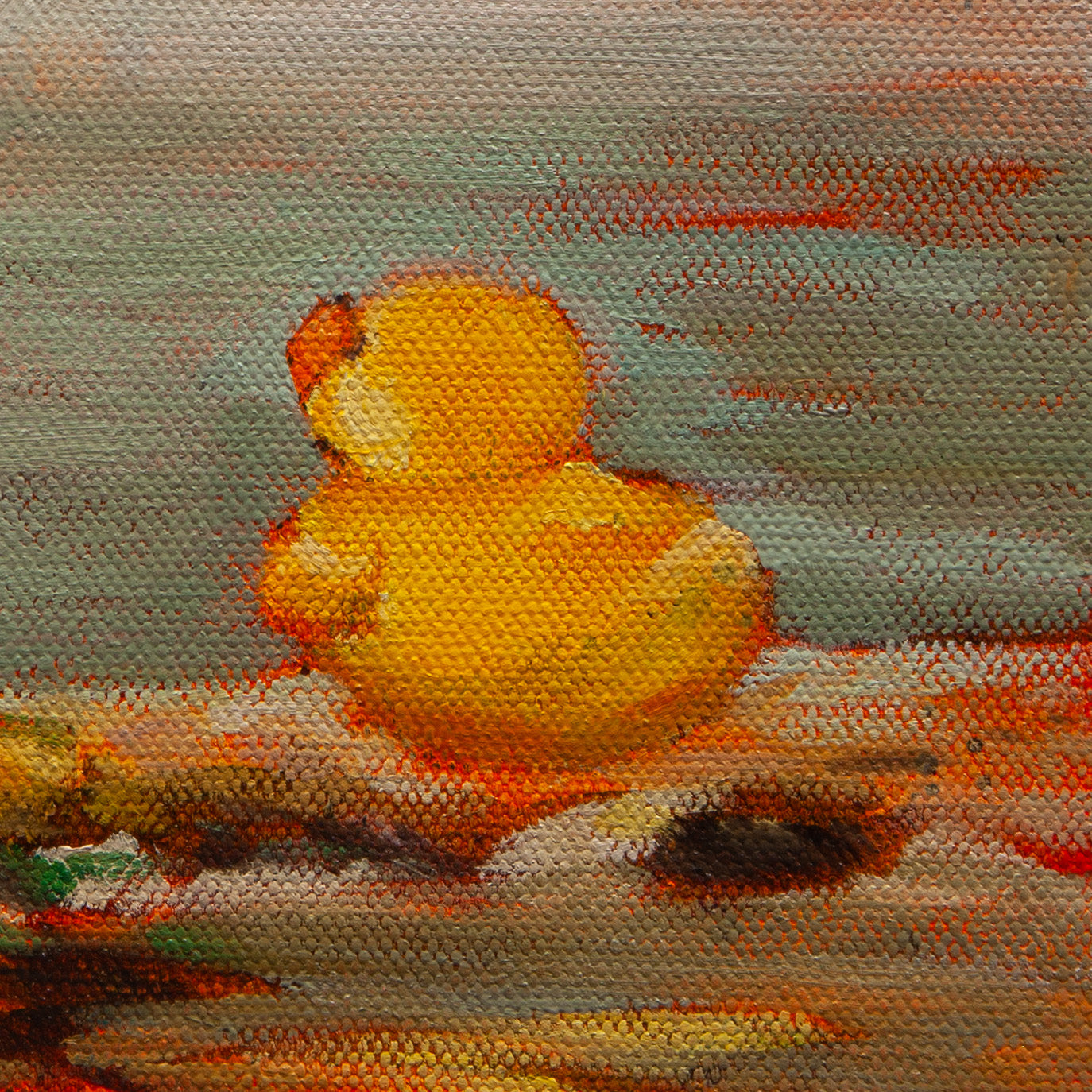 Close-up of a yellow rubber duck with orange beak in warm yellow, orange, and brown tones from Shoreline Company by Martina Goulart.
