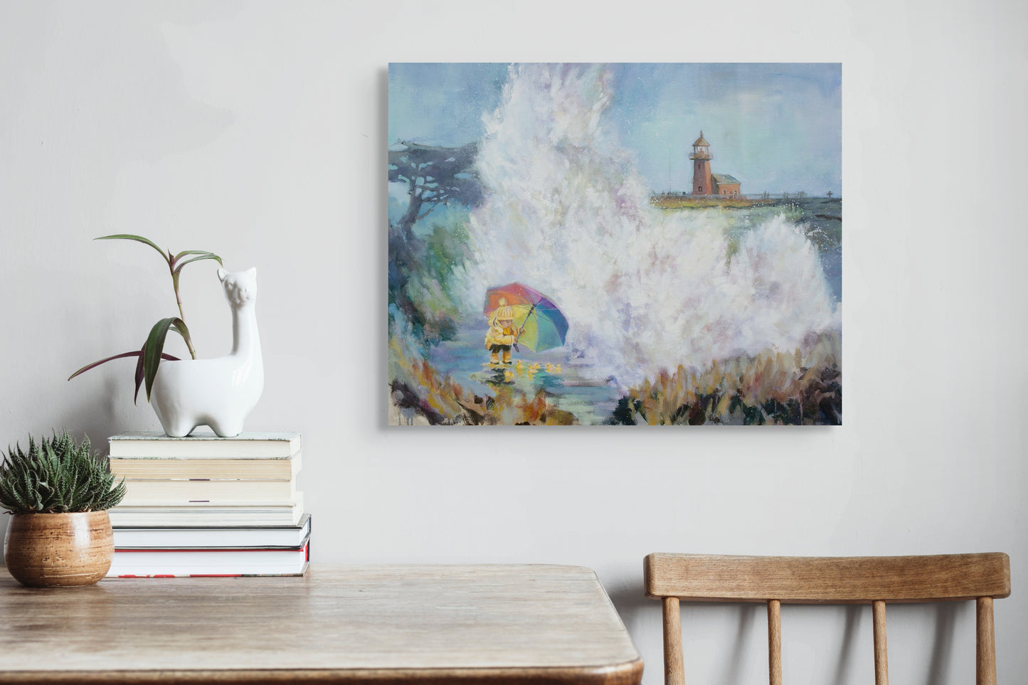 Original painting of a lighthouse and big wave with a girl in a yellow coat holding a rainbow umbrella, protecting rubber ducks at Santa Cruz West Cliff Drive.