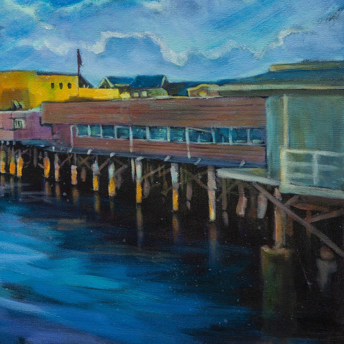 Detail of mint, pink, and yellow pier buildings on stilts above dark water, soft blue clouds overhead from Echoes of Monterey, coastal art.