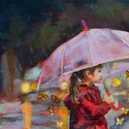 Close-up of the girl’s brown hair and the top of her pink umbrella with cars’ headlights reflecting on the wet street behind her.