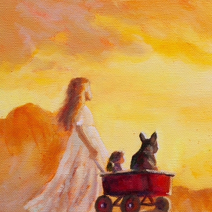 Close-up of a girl standing on a mountain at sunrise with a red wagon beside her. A small dog and a doll sit inside the wagon. Warm orange light from the sunrise glows behind them.