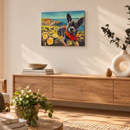 Colorful oil painting of a Chihuahua wearing a red bandana among coastal wildflowers, displayed above a natural wood console in a warm, sunlit modern living room with neutral decor and a sculptural ceramic vase.