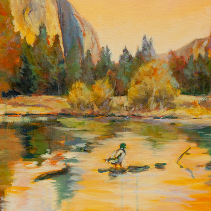 Detail of mallard duck resting on log in sunlit river with yellow-green trees, El Capitan cliffs, and orange reflections from The Peace of Play.