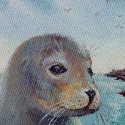 Close-up of the seal’s face in soft pastel light, with detailed whiskers, gentle lavender and teal shadows, and a calm expression against the pale blue sky.