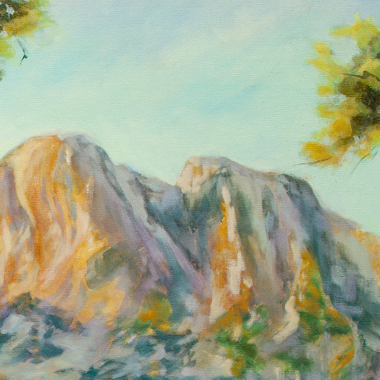 Close-up of soft blue and purple mountains with orange-yellow highlights and sunny sky from Wearing the Wild by Martina Goulart.