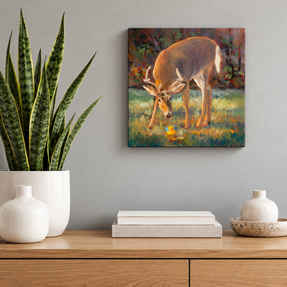 Small square deer oil painting by Martina Goulart featuring a curious buck and yellow rubber duck, displayed above a wooden cabinet with a snake plant and minimalist decor.