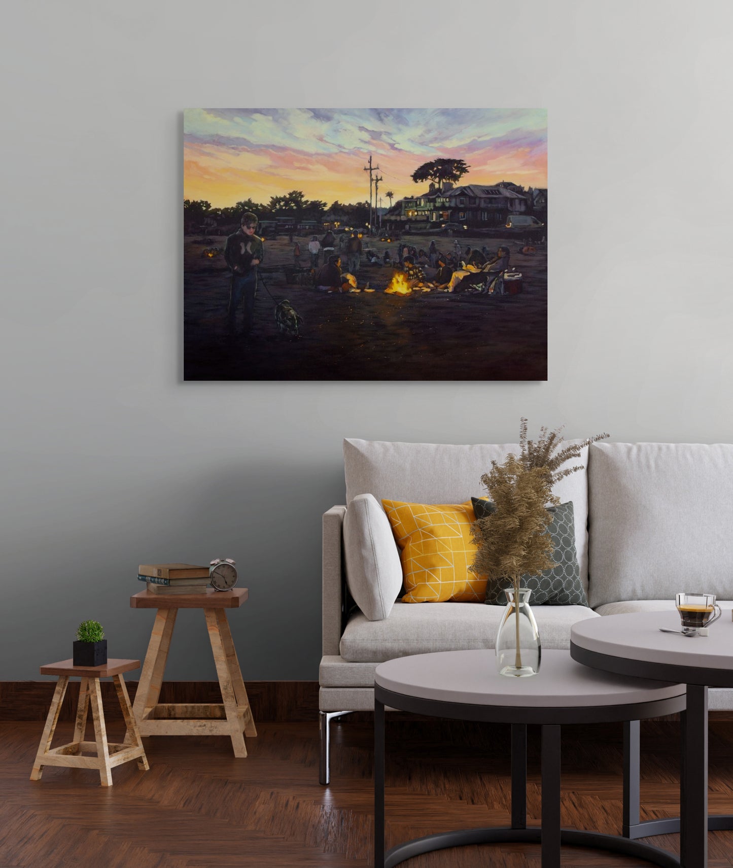 Painting Where the Night Begins hanging above a light modern couch with pillows, glass vase on coffee table, and two stools in a cozy living room.