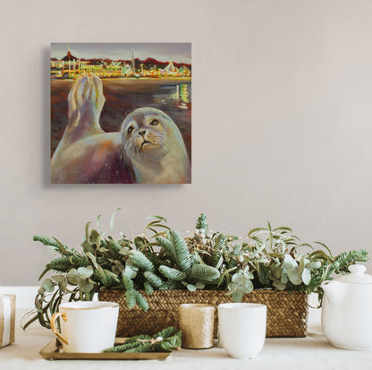 Seal painting on a wall above a table with plants and tea set.