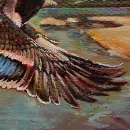 Close-up of a bird's wing with a blurred natural landscape in the background