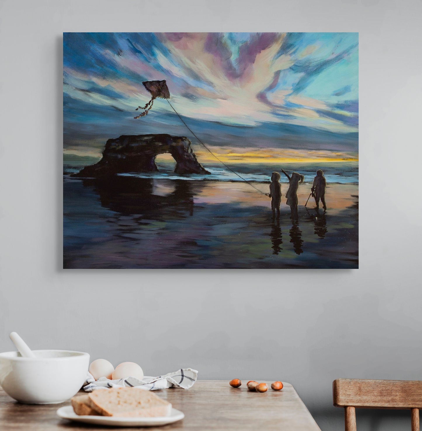 Painting Threads of Light showing children flying a kite at sunset hanging above a table set for breakfast in a cozy, light-filled room.