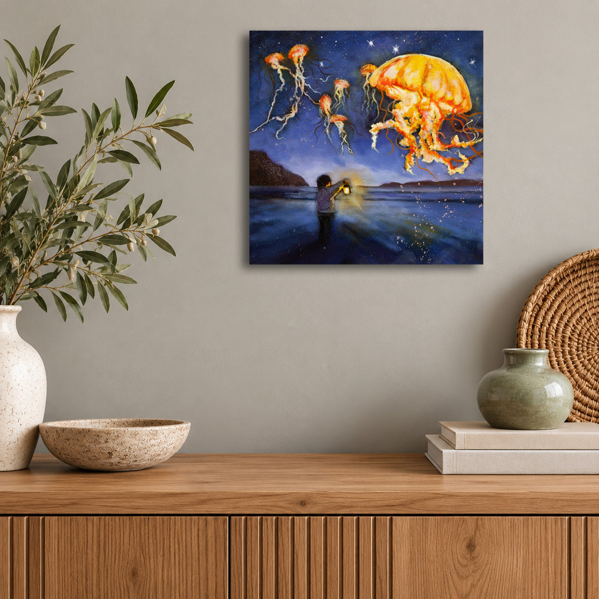 “Lantern for the Wild” original oil painting by Martina Goulart, featuring a child holding a lantern beneath glowing orange jellyfish floating over the ocean at night, displayed in a modern living space.
