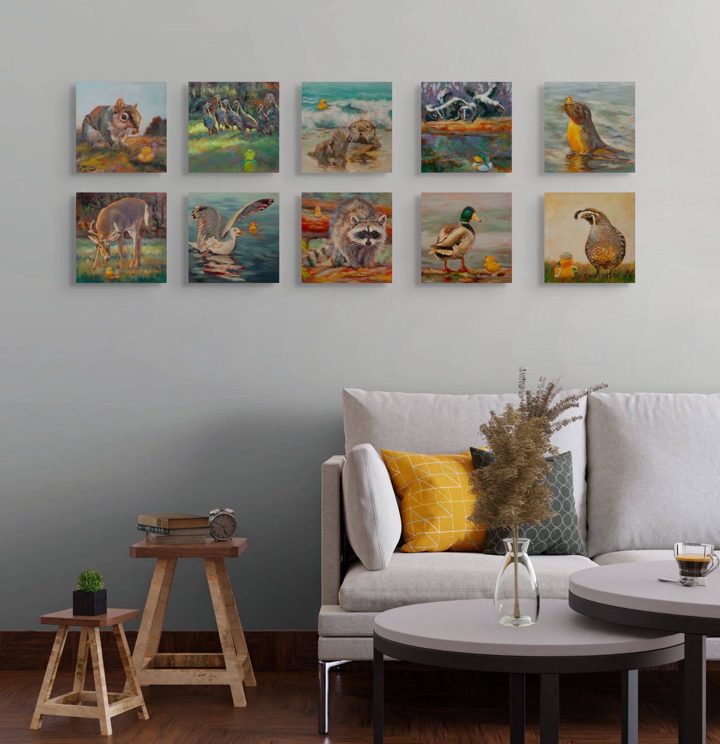 All ten Wild Neighbors paintings displayed above a white couch with pillows and a small stool, original wildlife art collection by Martina Goulart.