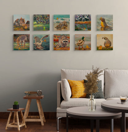 All ten Wild Neighbors paintings displayed above a white couch with pillows and a small stool, original wildlife art collection by Martina Goulart.