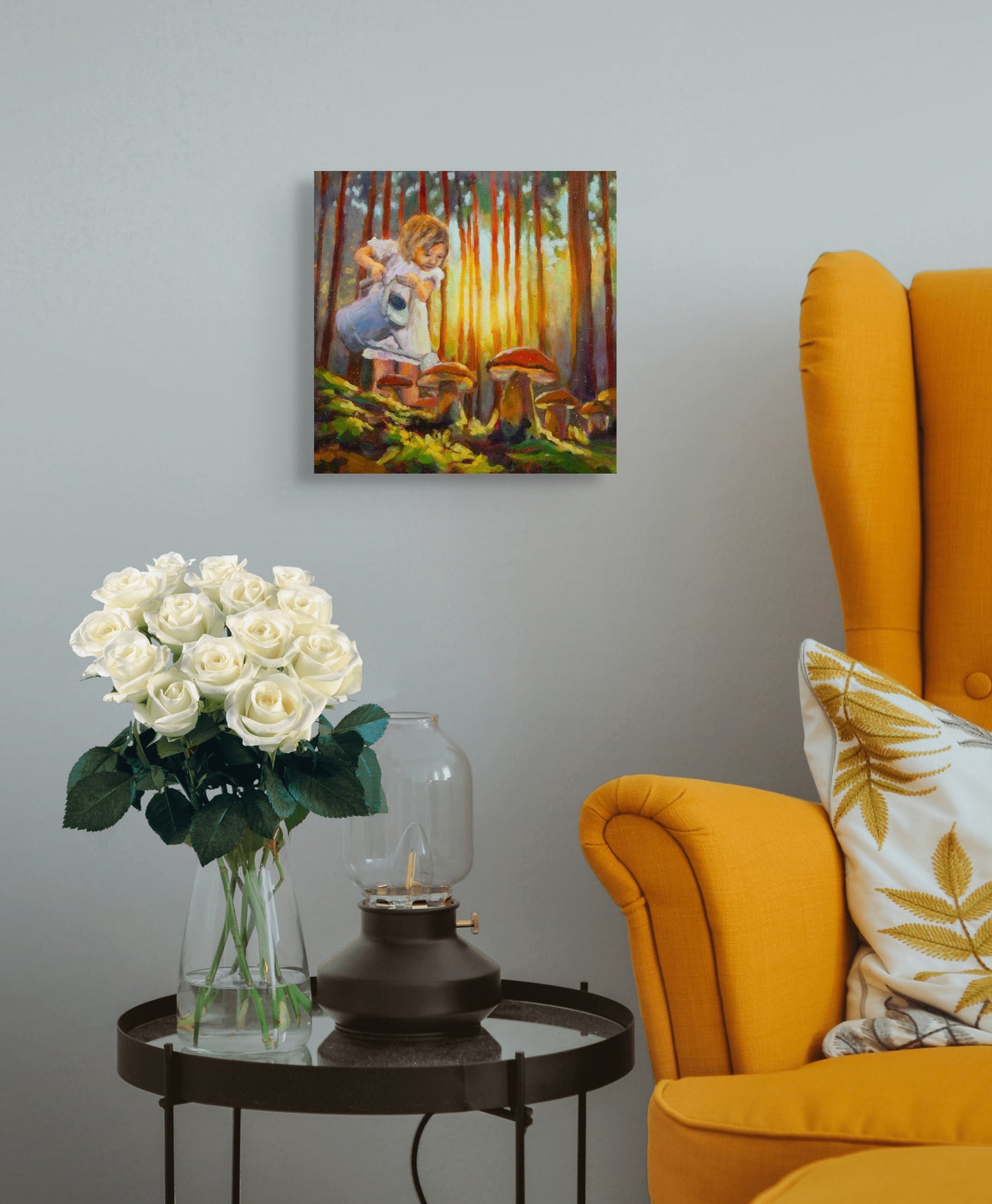 Painting of a young girl crouching to observe large mushrooms in glowing forest light, hanging above a side table with white roses and a yellow armchair nearby.