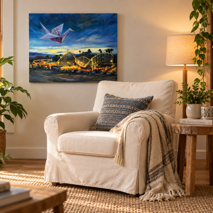Voyage of the Paper Crane displayed on a warm cream wall above a cozy white armchair, surrounded by natural wood, plants, a woven rug and soft lamplight.