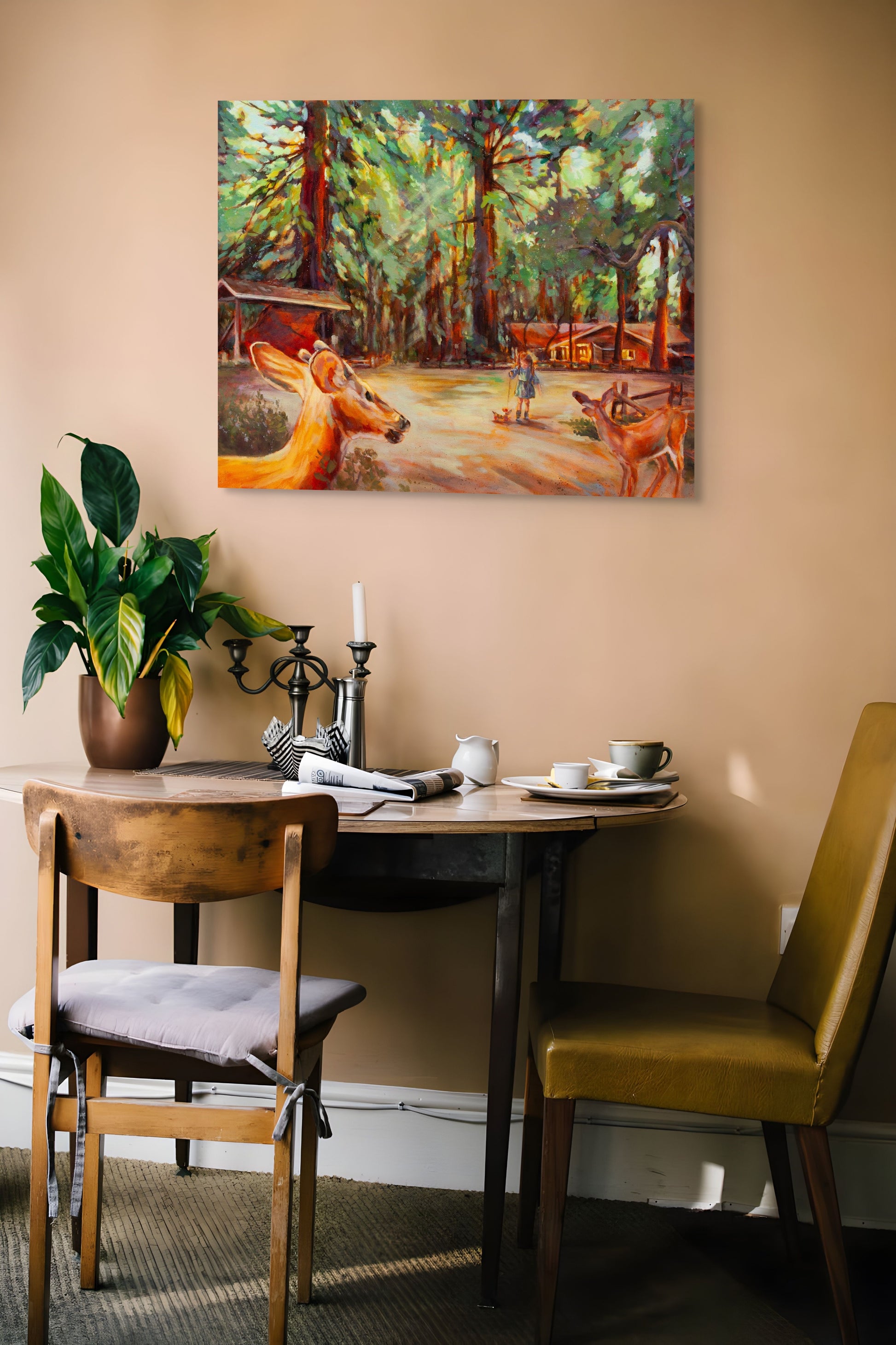 Painting Walking the Dog hanging on a brown wall above a wood table set for breakfast with two chairs, creating a warm, natural forest-inspired setting.