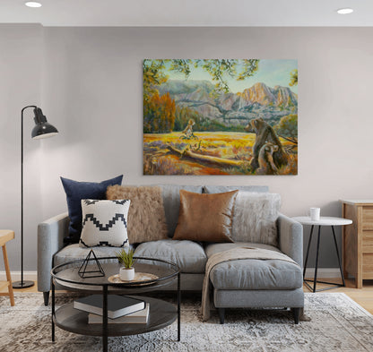 Painting Wearing the Wild hanging above a light gray couch with brown pillows, glass round coffee table, and neutral cozy living room decor.